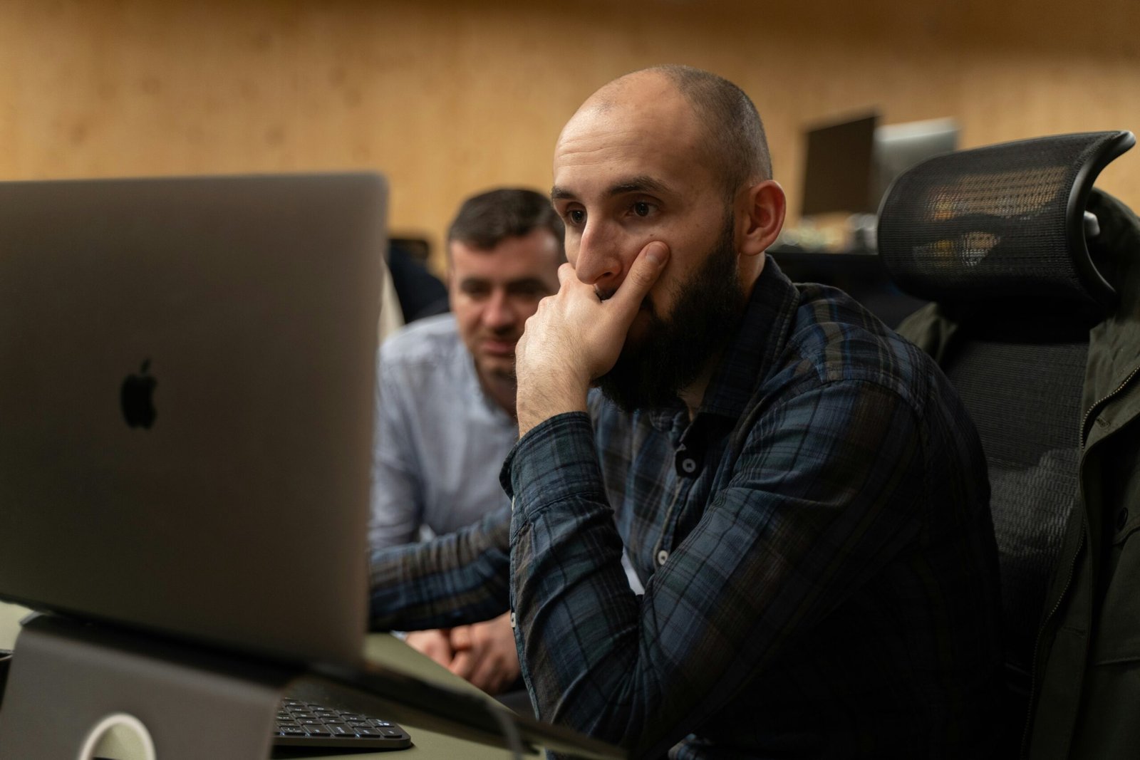 a man sitting in front of a laptop computer